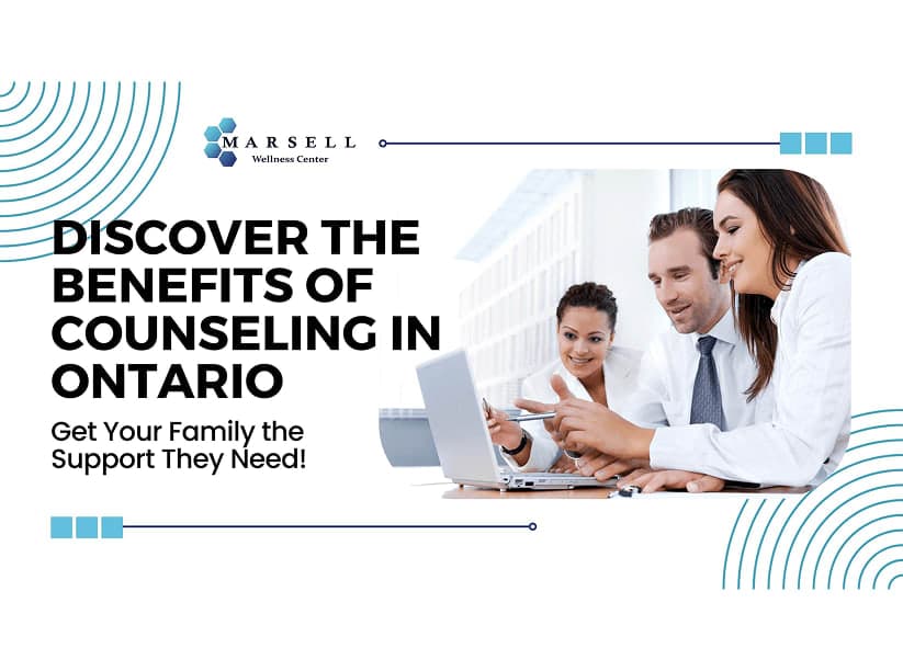 Three coworkers in a work setting looking and pointing at a computer.