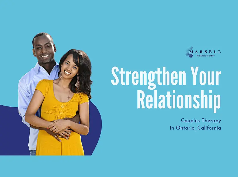 A happy couple embracing and smiling together.