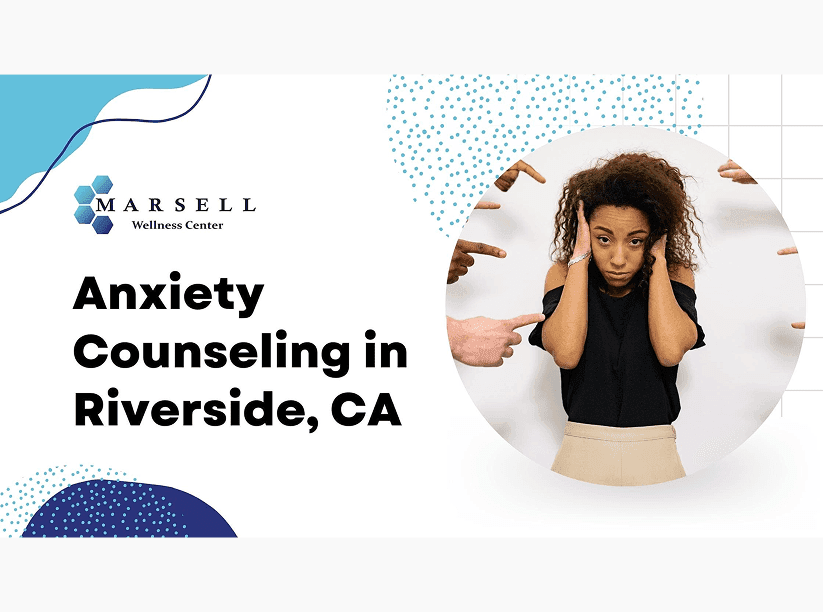 An anxious woman has her hands pressed against the sides of her head.